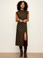 Sanctuary Autumn Edit Dress in Autumn Goldie Plaid — black and gold plaid midi dress with cap sleeves, mock neck, and front slit, styled with dark brown knee-high boots.