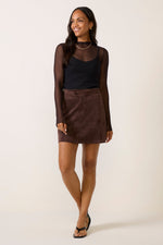 Z SUPPLY Perri Suede Mini Skirt in Dark Chocolate worn by model with black mesh top and sandals, front view