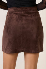 Z SUPPLY Perri Suede Mini Skirt in dark chocolate brown, back view on model wearing black long-sleeve top