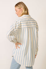 Free People Freddie Striped Shirt in Ivory Combo, back view on model showing oversized fit, blue and tan vertical stripes, long sleeves