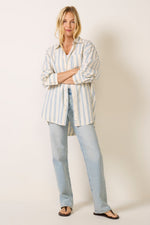 Free People Freddie Striped Shirt in Ivory Combo with blue stripes, oversized fit, worn with light wash jeans, front view on model