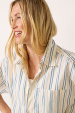 Free People Freddie Striped Shirt in Ivory Combo, close-up of model wearing cream shirt with blue vertical stripes and chest pocket
