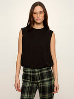 Sanctuary Quinn Bubble Shell in black, sleeveless with crew neck and elasticated hem, worn by model with plaid trousers, front view