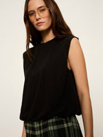 Sanctuary Quinn Bubble Shell in black, sleeveless with crew neck and relaxed silhouette, worn by model with plaid skirt, front view