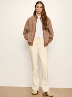 Sanctuary Zip Up Sweater Jacket in Heather Cocoa worn by model with cream flare pants, front view showing chunky knit texture