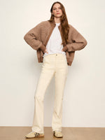 Sanctuary Zip Up Sweater Jacket in Heather Cocoa chunky knit, worn open over white tee with cream flare pants, front view on model.