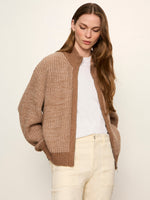 Sanctuary Zip Up Sweater Jacket in Heather Cocoa chunky knit with mock neck, worn open over white tee and cream pants, front view