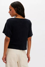 Free People Waterfall Cowl in Black, back view on model, showing relaxed boxy fit, flutter short sleeves, and center back seam detail.