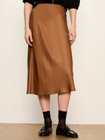 Sanctuary Everyday Midi Skirt in cocoa brown satin, A-line silhouette, styled with black loafers and sheer socks, front view on model