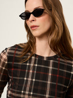 Sanctuary Mesh 3/4 Sleeve Top in Cinder Plaid worn by model, featuring dark brown, red, and cream tartan pattern with crew neck