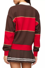 Z SUPPLY Study Break Polo Sweatshirt in Game Day Red — back view on model, brown and red colorblock stripes, white collar, paired with pleated mini skirt