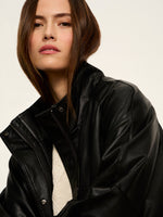 Sanctuary Alana Jacket in black leather worn by model, close-up showing zip front, snap collar, and oversized silhouette