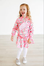 Mila Unicorn Kitties Belt Bag in pink worn by young girl in matching cat-print dress, front view