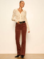 Sanctuary Dreamer Lace Shirt in Bone — cream floral lace collared top with long sleeves, worn by model with rust corduroy flare pants