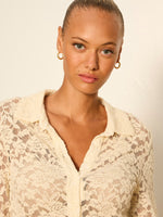 Sanctuary Dreamer Lace Shirt in bone — model wearing cream floral lace button-front collared shirt, close-up front view with gold hoop earrings