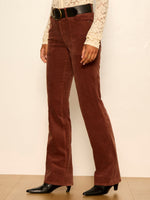 Sanctuary Play Date Corduroy Bootcut pants in Burnt Cocoa, side view on model with lace top and black belt