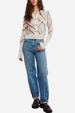 Free People Highland Mist Cardi in Sugar Mist Combo — cream plaid knit cardigan with rust and blue brushstroke pattern, gold buttons, on model with straight jeans.