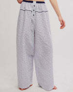 Free People Cross My Heart Lounge Pant in Ivory Combo, wide-leg striped pants with navy elastic waistband and button fly, front view on model