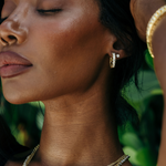 Sahira Piper CZ Hoops in gold worn by model, showcasing pavé crystal hoop earrings with matching stud, close-up side profile.