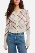 Free People Highland Mist Cardi in Sugar Mist Combo — cream plaid cardigan with orange and blue stripes, gold buttons, ribbed cuffs, worn with jeans.