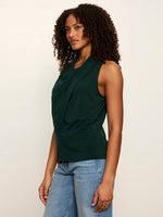 Sanctuary Nora Draped Tank in forest green with front drape detail, worn by model with blue jeans, side view