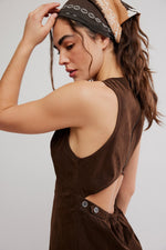 Free People Atlas Suede Mini in chocolate brown, back view on model showing open-back design with button detail and racerback silhouette.