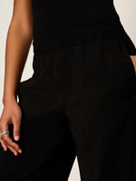 Sanctuary Micro Balloon Pant in black with elastic waistband, close-up detail view on model with silver rings