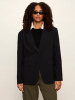 Sanctuary Maci Blazer in navy pinstripe, single-button front, notch lapels, flap pockets, worn over black sweater with olive cargo pants