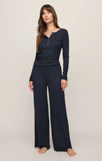 Z Supply Just Right Rib LS Top in Eclipse navy, long-sleeve henley with ruffle neckline, worn with matching wide-leg pants, front view.