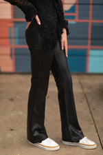 RD Style Fabiana Stretch Faux Leather Pull On flare pants in black, shown on model with white sneakers and black lace top