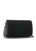 Haute Shore Lexi Woven Crossbody in Jet Black — angled view showing woven texture flap and silver chain strap