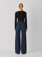 Z SUPPLY Ginger Bodysuit in black, back view on model, long-sleeve fitted knit top paired with wide-leg dark denim jeans