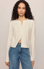 Z Supply Medina Pointelle Cardigan in Cloud, a cream button-front knit cardigan with pointelle texture, worn by a model with blue jeans.