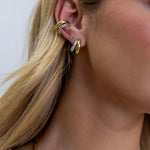 Sahira Kendall Two Tone Pave Hoop earrings in gold and crystal pavé worn on model's ear with matching ear cuff