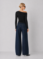 Steve Madden Ryder Knit Top in black, back view on model, featuring one-shoulder asymmetric neckline and long sleeve with ruching detail