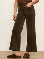 Sanctuary Chelsea Wide Leg corduroy pants in deep olive Kalamata, high-rise with patch pockets, worn by model with brown studded clogs