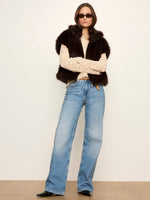Sanctuary Silky Fur Vest in Espresso Martini dark brown, worn by model over cream lace top with wide-leg blue jeans, front view