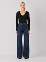 Z SUPPLY Ginger Bodysuit in black, long-sleeve with V-neckline cutout detail, worn by model with wide-leg dark jeans, front view