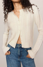 Z SUPPLY Medina Pointelle Cardigan in Cloud, cream cable-knit with pearl buttons, worn open over jeans, front view on model