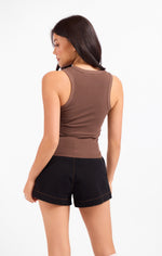 Sadie Ruby Studded Knit Tank in brown, back view on model, racerback silhouette with ribbed fabric, paired with black shorts