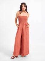 SADIE AND SAGE Sugarloaf Stripe Jumpsuit in mahogany, smocked bodice, wide-leg palazzo pants, spaghetti straps, front view on model