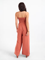 Sadie and Sage Sugarloaf Stripe Jumpsuit in Mahogany, back view on model, smocked bodice, spaghetti straps, wide-leg pants