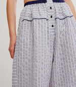 Free People Cross My Heart Lounge Pant in Ivory Combo, close-up detail of navy stripe seersucker fabric, elastic waist, and front button placket on model.