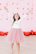 Mila Better Together L/S Tutu Dress in white with heart print top and pink tulle skirt, worn by girl tossing confetti
