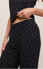 Z SUPPLY Luxe Dot Pant in black with white polka dots, close-up detail shot showing elastic waistband on model