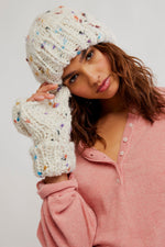 Free People Speckled Cph Set in ivory chunky knit beanie and fingerless gloves with multicolor fleck detail, worn by model in pink top