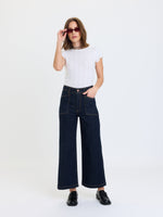 Daze Denim Valley Girl High Rise Patch Pocket Wide Ankle jeans in Rinse, front view on model with white tee and black loafers