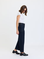 Daze Denim Valley Girl High Rise Patch Pocket Wide Ankle jeans in Rinse, side view on model with white tee and black loafers