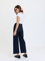 Daze Denim Valley Girl High Rise Patch Pocket Wide Ankle jeans in Rinse, back view on model with white tee and black loafers