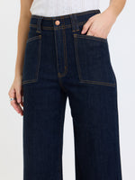 Daze Denim Valley Girl High Rise Patch Pocket Wide Ankle jeans in Rinse, close-up front view showing patch pockets and gold stitching